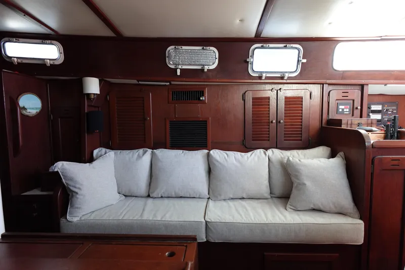 Slide: The Image of Interior of 1978 Morgan 382 sailboat with wooden paneling and cushioned seating. - 35