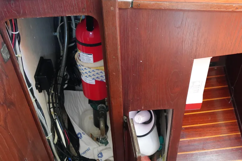Slide: The Image of 1978 Morgan 382 yacht interior showing fire extinguisher and storage compartments. - 43
