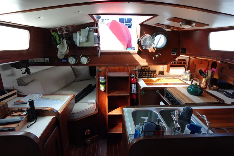 Slide: The Image of Interior of a 1978 Morgan 382 sailboat with cozy seating and a compact kitchen. - 47