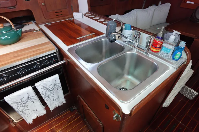 Slide: The Image of 1978 Morgan 382 yacht kitchen with dual sinks, stove, and wooden countertops. - 67