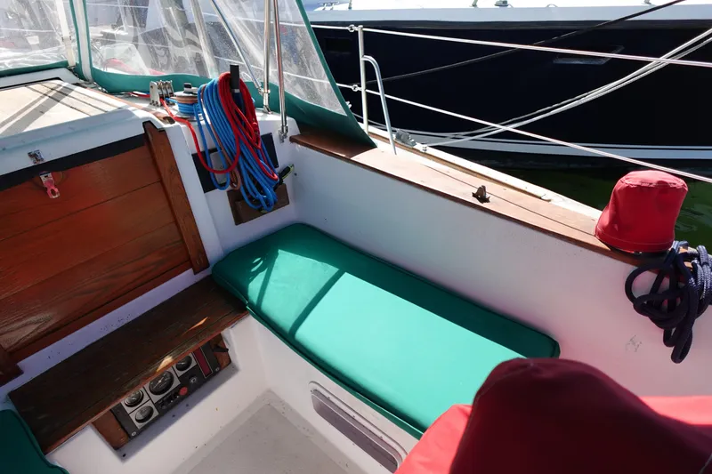 Slide: The Image of 1978 Morgan 382 sailboat cockpit with green cushions and nautical equipment. - 87