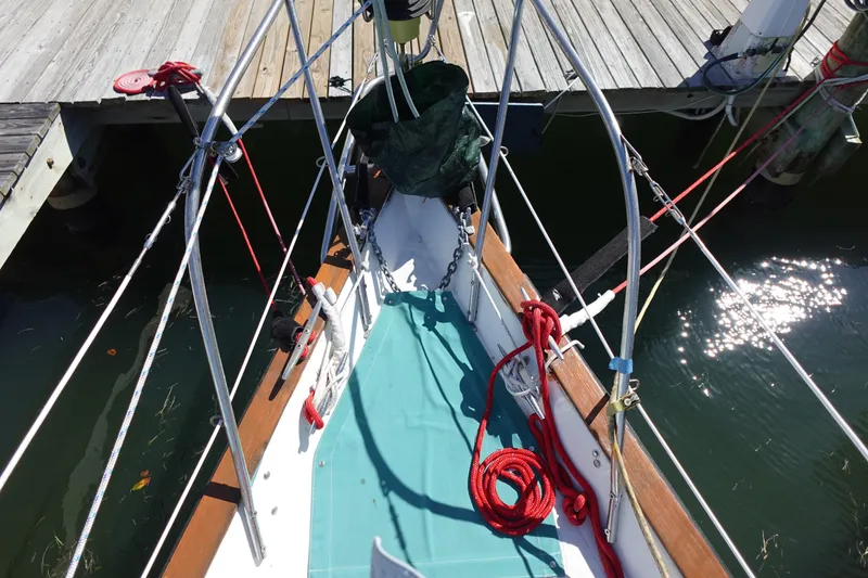 Slide: The Image of 1978 Morgan 382 sailboat bow with ropes and dock, sunlight reflecting on water. - 9