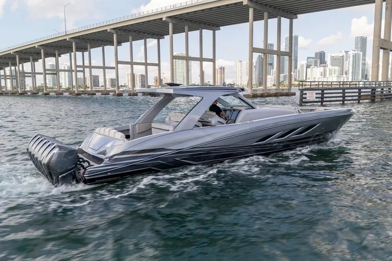 The Image of 2026 Deep Impact 499 Sport boat cruising under a bridge with city skyline in background. - 0