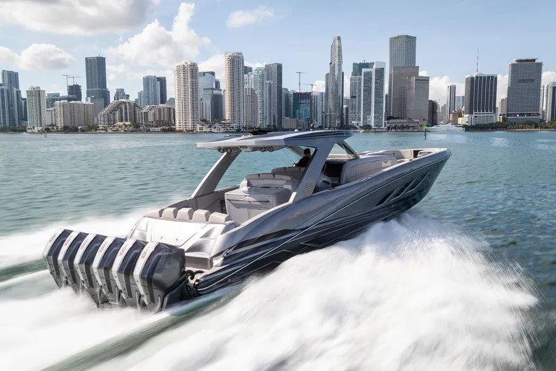 Slide: The Image of Luxury Deep Impact 499 Sport boat cruising near city skyline, 2026 model. - 10