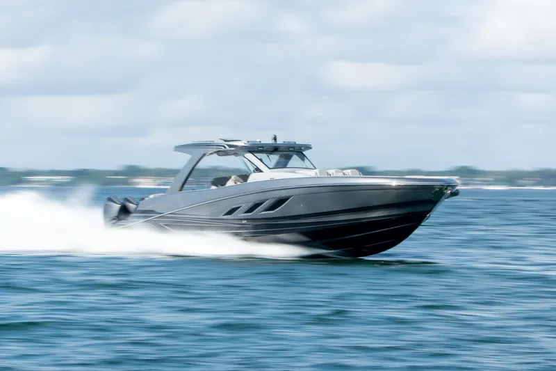Slide: The Image of 2026 Deep Impact 499 Sport boat speeding on open water, showcasing sleek design and performance. - 12