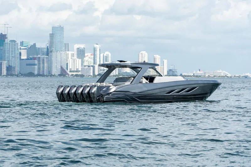 Slide: The Image of Luxury Deep Impact 499 Sport boat cruising near city skyline, 2026 model. - 17