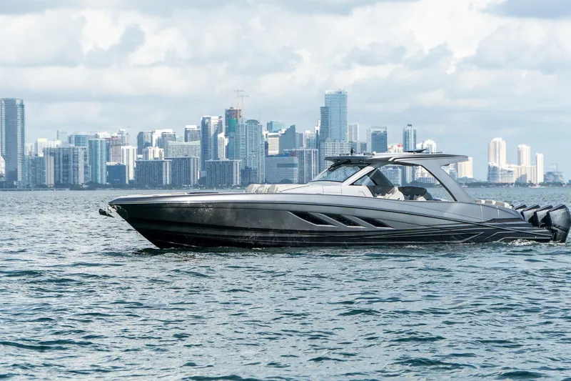 Slide: The Image of Luxury Deep Impact 499 Sport boat cruising near city skyline, 2026 model. - 20