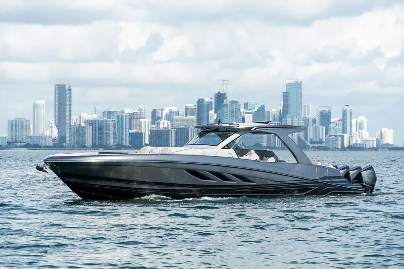 Slide: The Image of Luxury Deep Impact 499 Sport boat cruising near city skyline, 2026 model. - 21