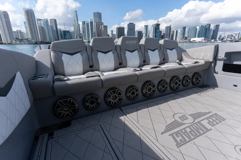 Slide: The Image of Luxury seating on 2026 Deep Impact 499 Sport boat with city skyline backdrop. - 24