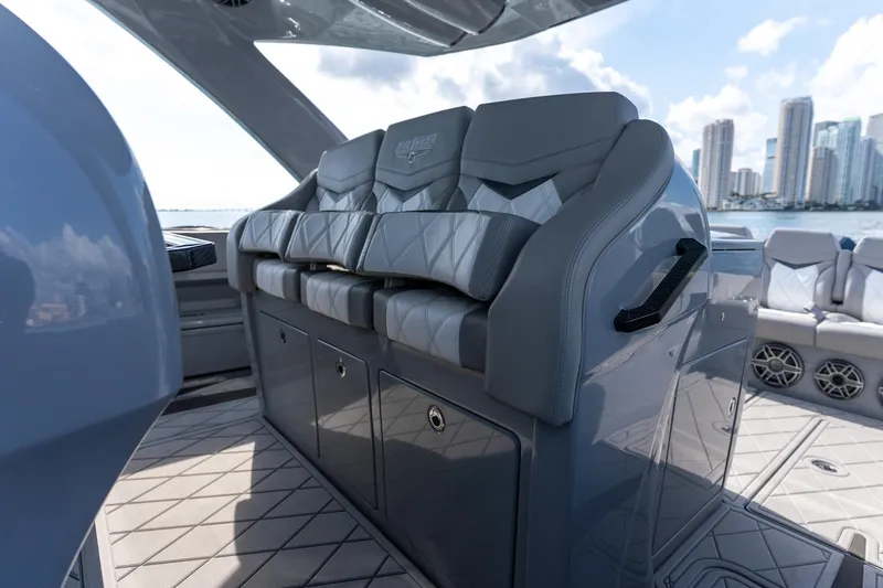 Slide: The Image of Luxurious seating on 2026 Deep Impact 499 Sport boat with city skyline backdrop. - 25