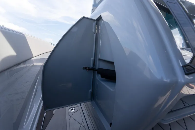 Slide: The Image of Open storage compartment on 2026 Deep Impact 499 Sport boat, showcasing sleek design. - 28