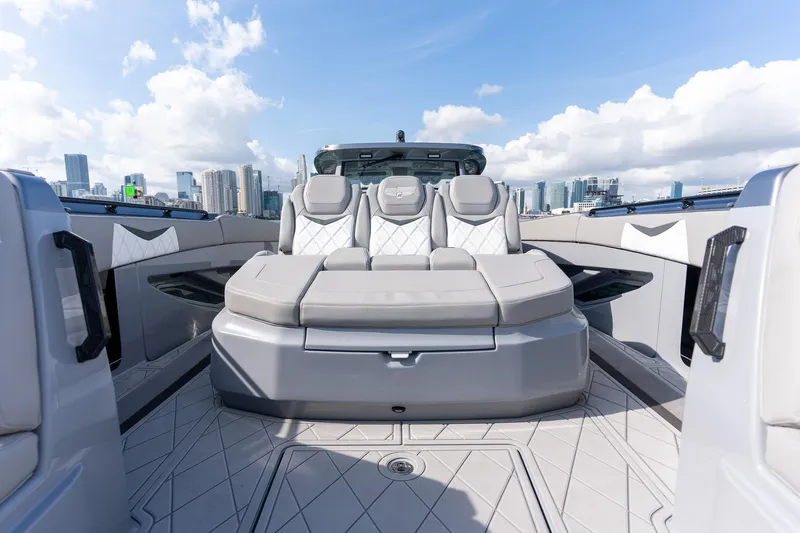 Slide: The Image of Luxury seating on 2026 Deep Impact 499 Sport boat with city skyline backdrop. - 32