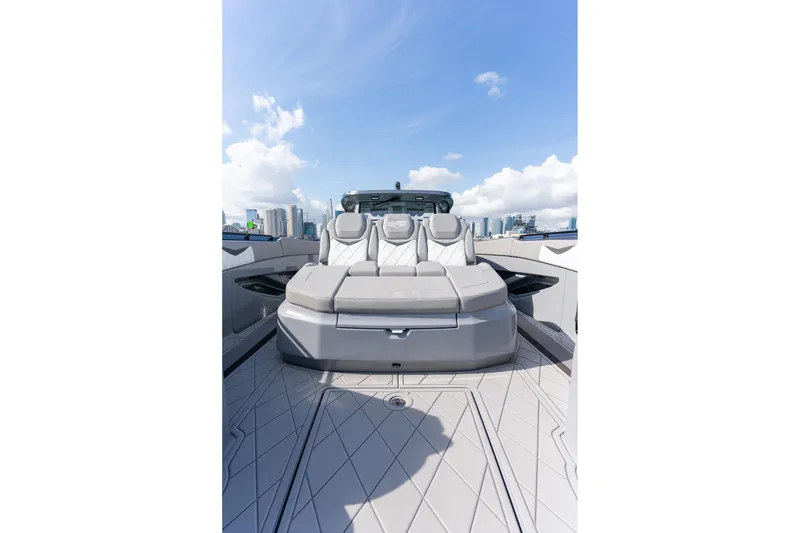 Slide: The Image of 2026 Deep Impact 499 Sport luxury boat with sleek seating, city skyline in background. - 33
