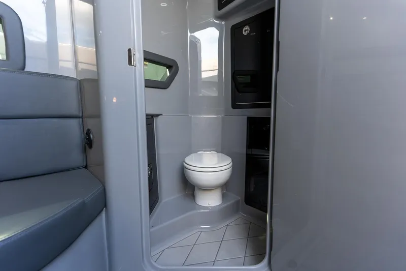 Slide: The Image of Interior of 2026 Deep Impact 499 Sport boat featuring a compact bathroom. - 38