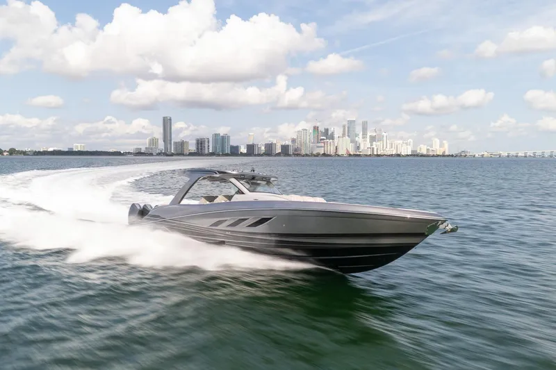 Slide: The Image of 2026 Deep Impact 499 Sport speedboat cruising near city skyline on a sunny day. - 4