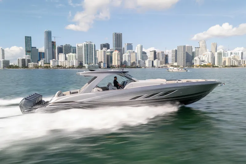 Slide: The Image of 2026 Deep Impact 499 Sport boat cruising near city skyline on a sunny day. - 7