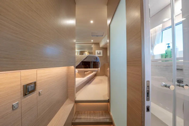 Slide: The Image of Luxurious Horizon yacht interior with modern wood paneling and elegant lighting, 2021 model. - 26