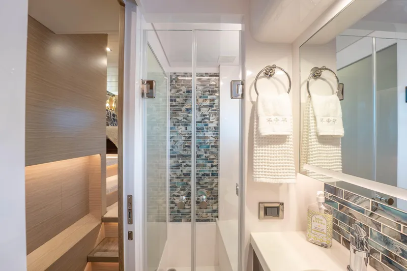 Slide: The Image of Modern yacht bathroom with glass shower, elegant tiles, and luxury amenities, Horizon 2021. - 28