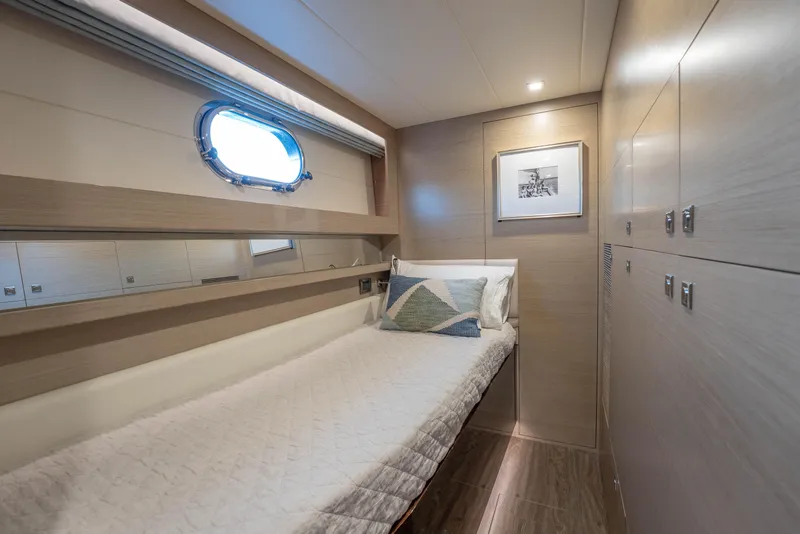Slide: The Image of Luxurious 2021 Horizon yacht cabin with single bed, porthole, and modern decor. - 36