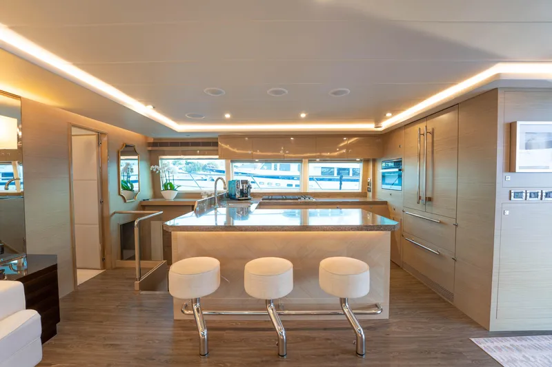 Slide: The Image of Luxurious Horizon yacht interior with modern kitchen, island, and bar stools, 2021 model. - 4