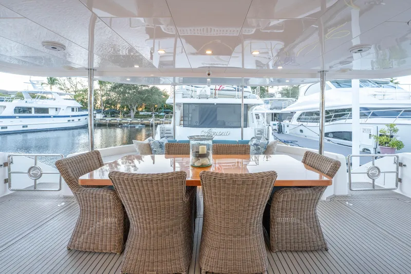Slide: The Image of Luxurious Horizon yacht deck with wicker dining set, docked at marina, 2021 model. - 43