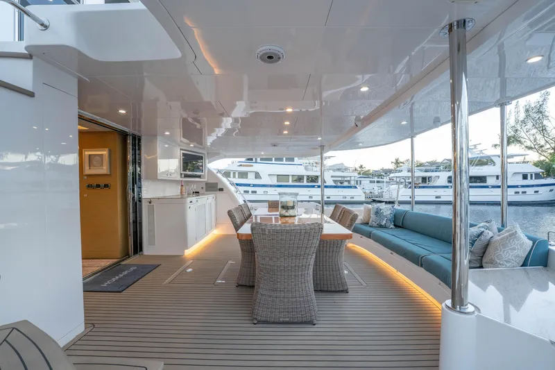 Slide: The Image of Luxurious Horizon yacht deck with dining area and seating, docked at marina, 2021 model. - 45