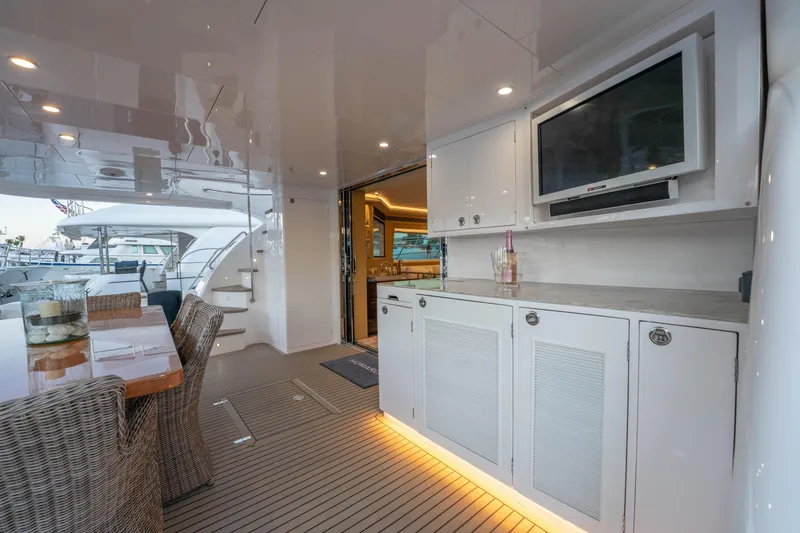 Slide: The Image of Luxurious Horizon yacht deck with dining area, TV, and elegant cabinetry, 2021 model. - 49
