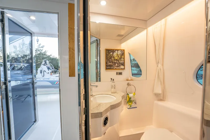 Slide: The Image of Luxurious yacht bathroom with modern fixtures, large mirror, and scenic window view, Horizon 2021. - 53