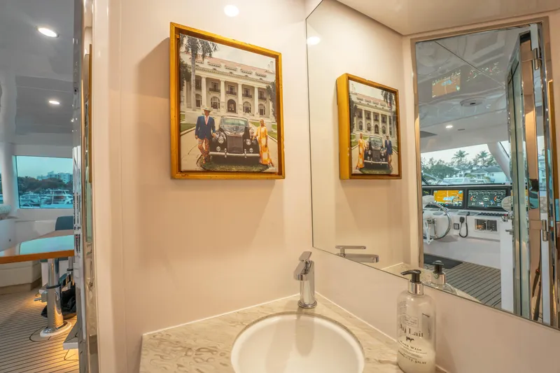 Slide: The Image of Luxurious yacht bathroom with framed photo, modern sink, and view of the helm. Horizon 2021. - 54