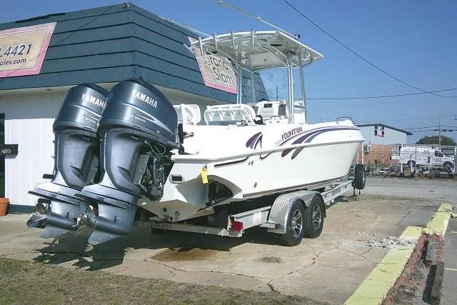 Slide: The Image of 1996 Fountain 31 Center Console boat with dual Yamaha engines on a trailer. - 11