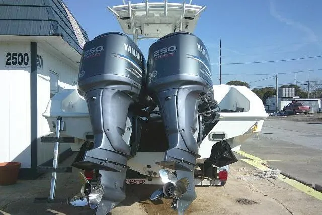 Slide: The Image of 1996 Fountain 31 Center Console with twin Yamaha 250 outboard motors, parked outdoors. - 12