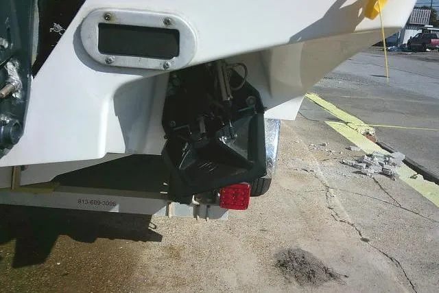 Slide: The Image of 1996 Fountain 31 Center Console boat stern with trailer and trim tab visible. - 14