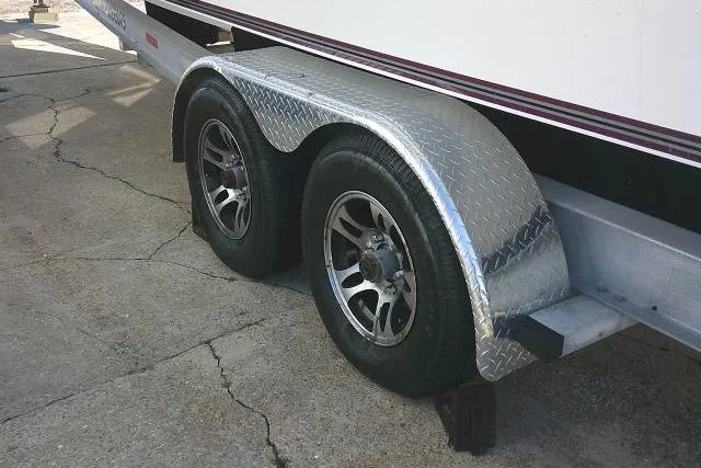 Slide: The Image of Trailer wheels of a 1996 Fountain 31 Center Console boat on concrete surface. - 19