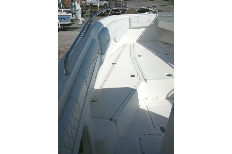 Slide: The Image of 1996 Fountain 31 Center Console boat interior with white seating and storage compartments. - 21