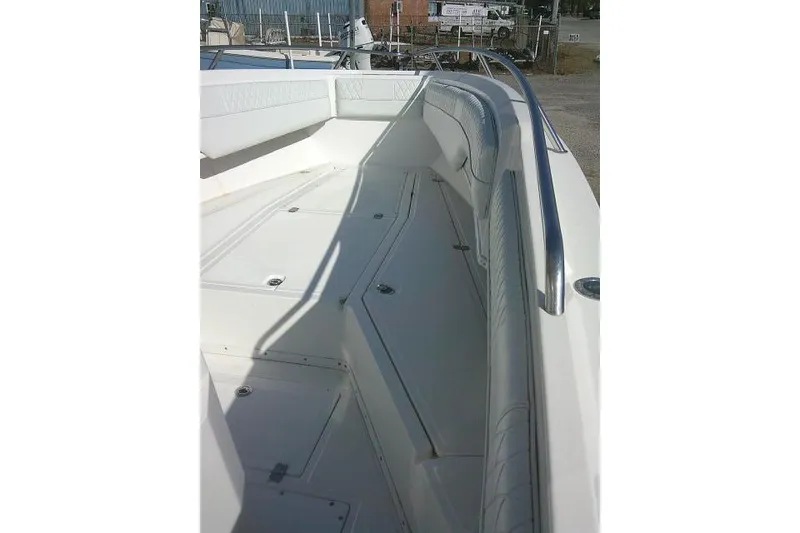 Slide: The Image of 1996 Fountain 31 Center Console boat interior with white seating and storage compartments. - 22
