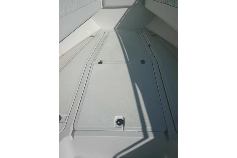 Slide: The Image of 1996 Fountain 31 Center Console boat deck with storage compartments. - 23