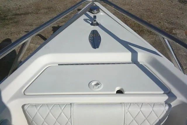 Slide: The Image of 1996 Fountain 31 Center Console boat bow with stainless steel railings and storage compartment. - 24