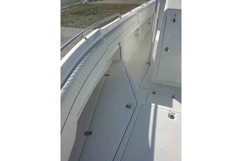 Slide: The Image of 1996 Fountain 31 Center Console boat interior with cushioned seating and storage compartments. - 26