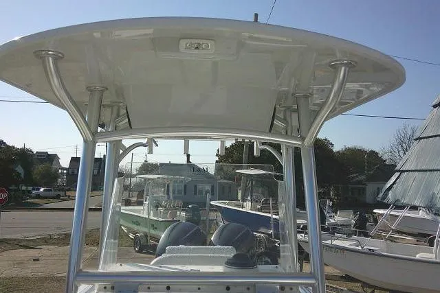 Slide: The Image of 1996 Fountain 31 Center Console boat with T-top, docked in a marina setting. - 29