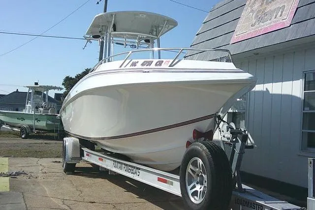 Slide: The Image of 1996 Fountain 31 Center Console boat on trailer, parked outdoors near a building. - 3
