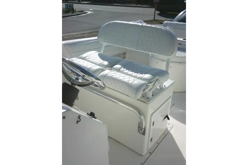 Slide: The Image of 1996 Fountain 31 Center Console boat with white quilted seating and steering wheel. - 33