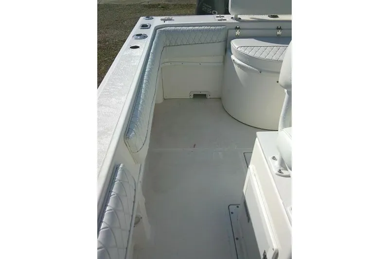 Slide: The Image of 1996 Fountain 31 Center Console boat interior with cushioned seating and storage compartments. - 36