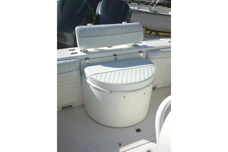 Slide: The Image of 1996 Fountain 31 Center Console boat interior with cushioned seating and storage. - 37