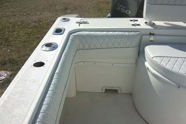 Slide: The Image of 1996 Fountain 31 Center Console boat interior with cushioned seating and rod holders. - 38