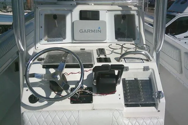 Slide: The Image of 1996 Fountain 31 Center Console boat dashboard with Garmin navigation system. - 44
