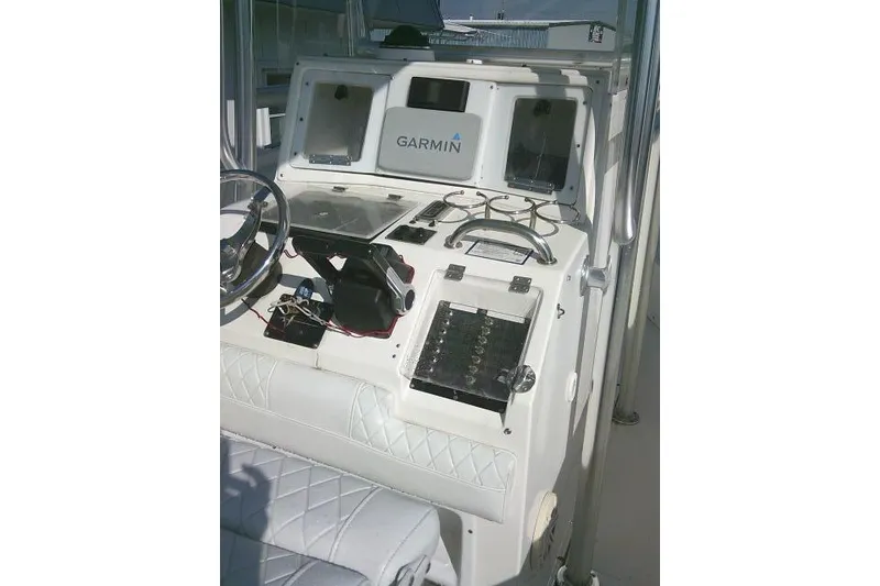 Slide: The Image of 1996 Fountain 31 Center Console boat dashboard with Garmin navigation system. - 45