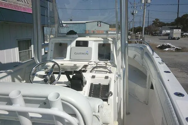 Slide: The Image of 1996 Fountain 31 Center Console boat with Garmin navigation system, docked in a marina. - 54