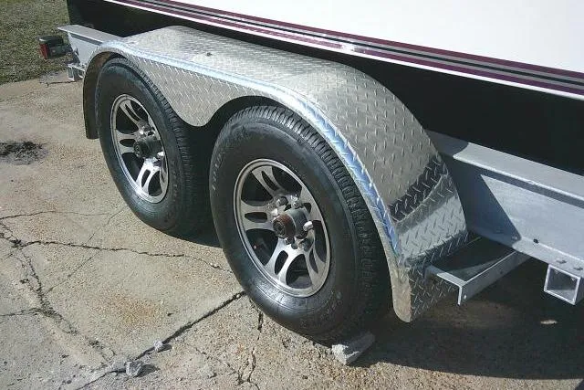 Slide: The Image of Trailer wheels for 1996 Fountain 31 Center Console boat on concrete surface. - 7