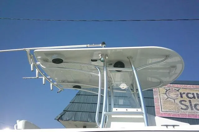 Slide: The Image of 1996 Fountain 31 Center Console boat with T-top against clear blue sky. - 8