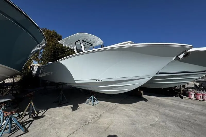 The Image of 2026 Sportsman Open 252 Center Console boat on display in a marina. - 1